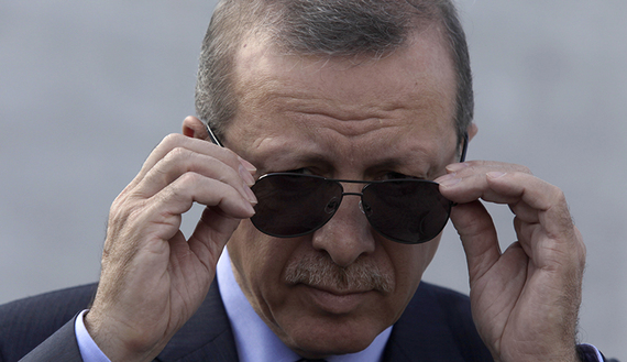 Turkey's President Recep Tayyip Erdogan adjusts his sunglasses before a wreath-laying ceremony at the Jose Marti monument in Havana